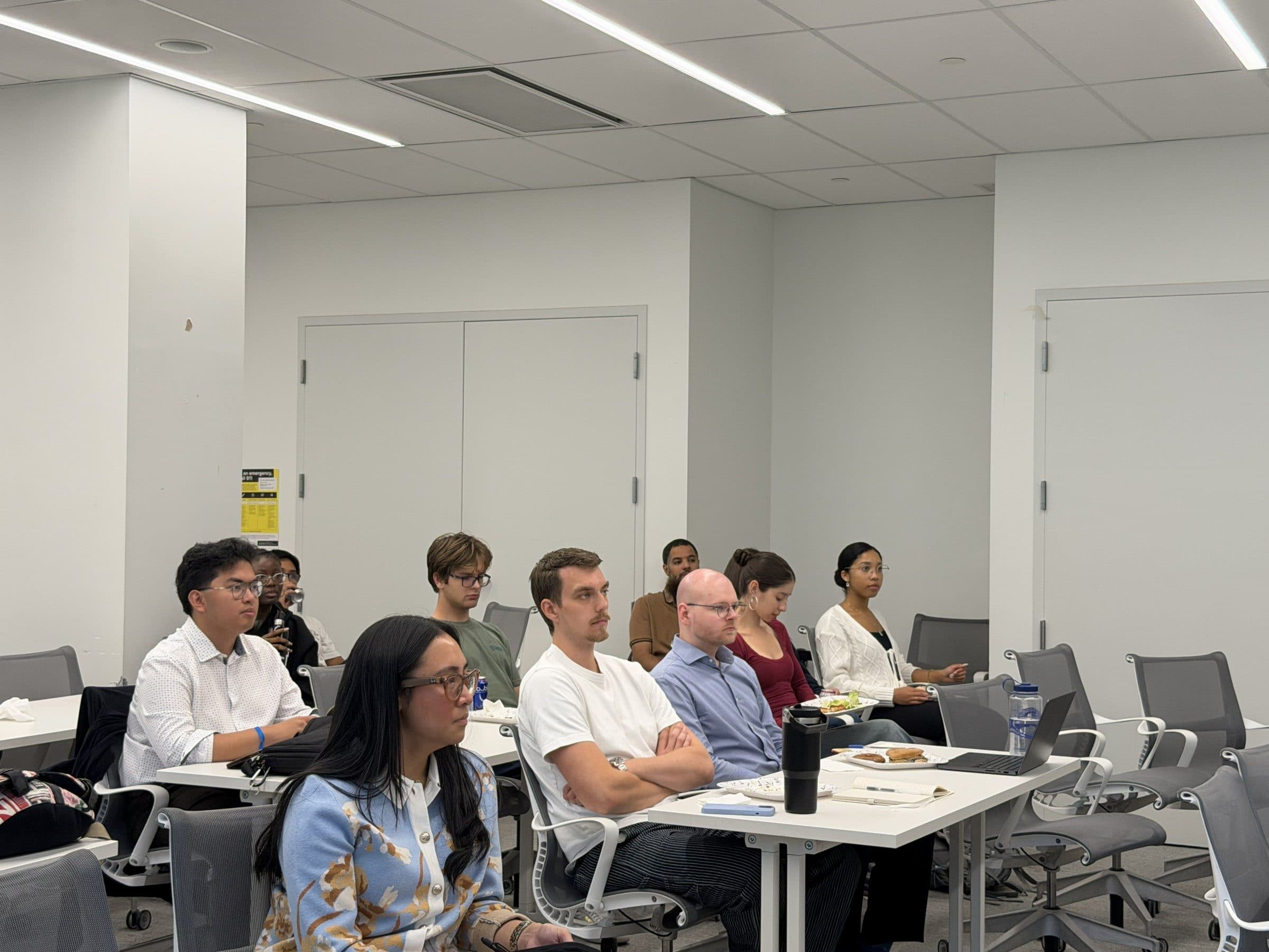 Michelle Jadormeo listens from the front row among seminar attendees.